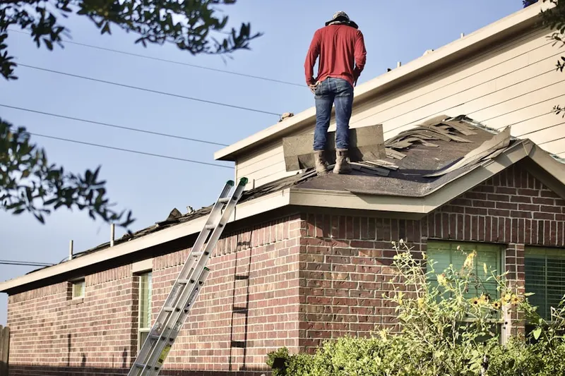 Professional roofer working on a residential roof in Holford